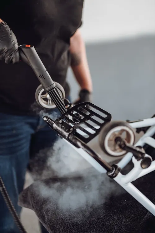 Steam cleaning a wheelchair footplate.